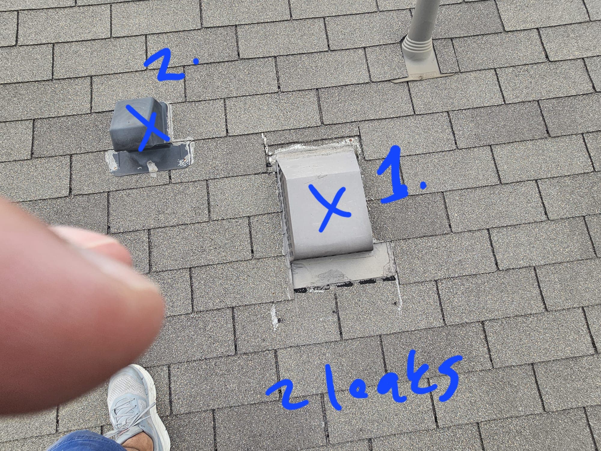 Roof inspection photo with two leak spots hand-marked in blue marker — Jerrys Roofing documentation