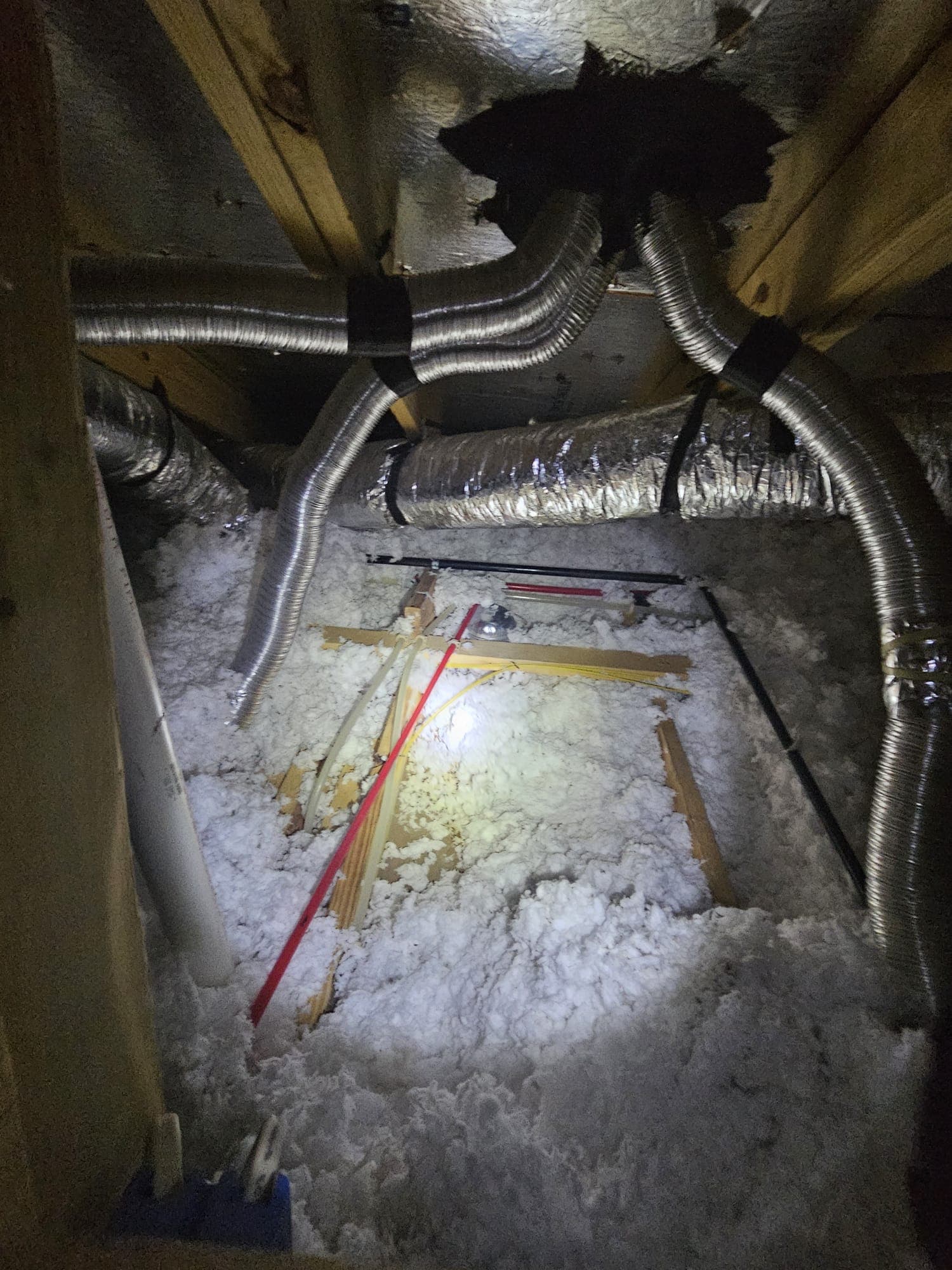 Attic interior inspection showing insulation and flex ducting — part of a Jerrys Roofing inspection